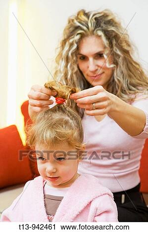 Stock Image - Hairdressing toddler girl. Fotosearch