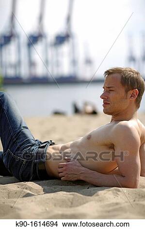 Halb body image of young caucasian man, seen from the side View Large Photo Image Picture - Halb body image of young caucasian man, seen from the side. Fotosearch