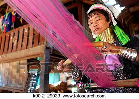 Half body image of Longneck Karen woman sitting on the floor and weaving a pink scarf, Mae Hong Son, Thailand, Southeast Asia. View Large Photo Image Stock Image - Half body image of Longneck Karen woman sitting on the floor and weaving a pink scarf, Mae Hong Son, Thailand, Southeast Asia.. Fotosearch