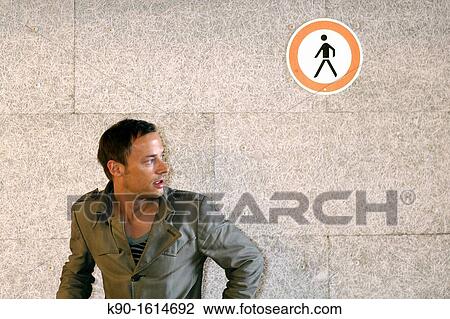 Half body image of young caucasian man with coat, looking to the side, surprised with open mouth, grey-brown wall behind him with a sign? pedestrians forbidden?, Hamburg, Germany, Europe View Large Photo Image Stock Image - Half body image of young caucasian man with coat, looking to the side, surprised with open mouth, grey-brown wall behind him with a sign? pedestrians forbidden?, Hamburg, Germany, Europe. Fotosearch