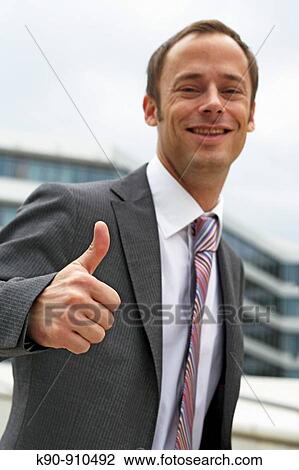 Half body photograph of smiling young, caucasian business man in suit and tie, with thumbs-up sign, Hamburg, Germany, Europe View Large Photo Image Stock Image - Half body photograph of smiling young, caucasian business man in suit and tie, with thumbs-up sign, Hamburg, Germany, Europe. Fotosearch