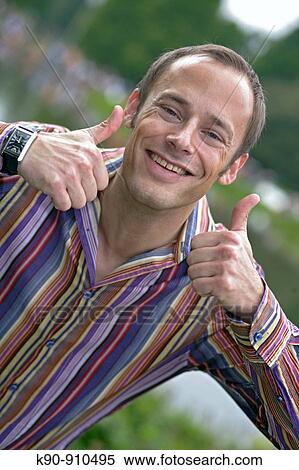 Half body photograph of smiling young, caucasian business man in suit and tie, with double thumbs-up sign, Hamburg, Germany, Europe View Large Photo Image Stock Photography - Half body photograph of smiling young, caucasian business man in suit and tie, with double thumbs-up sign, Hamburg, Germany, Europe. Fotosearch