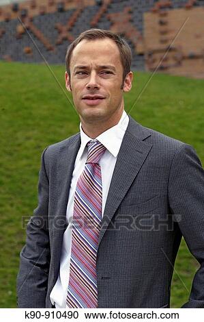 Half body photograph of young, caucasian business man in grey suit, looking to the far distance, Hamburg, Germany, Europe View Large Photo Image Stock Image - Half body photograph of young, caucasian business man in grey suit, looking to the far distance, Hamburg, Germany, Europe. Fotosearch