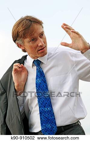 Half body photograph of young, caucasian business man in white shirt, wearing his suit jacket over the shoulder and making a heavy gesture with his hand while having a conversation, Hong Kong, China, Asia View Large Photo Image Stock Image - Half body photograph of young, caucasian business man in white shirt, wearing his suit jacket over the shoulder and making a heavy gesture with his hand while having a conversation, Hong Kong, China, Asia. Fotosearch