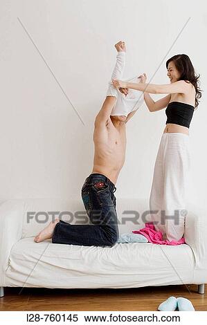 Half Dressed Young Couple staying on a Sofa View Large Photo Image Stock Photography - Half Dressed Young Couple staying on a Sofa. Fotosearch