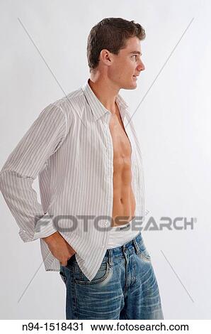 Half-length photograph of a teenage boy putting on his white shirt. View Large Photo Image Stock Image - Half-length photograph of a teenage boy putting on his white shirt.. Fotosearch