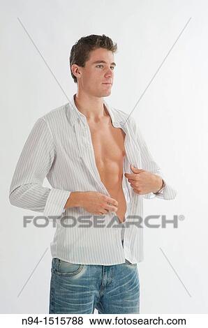 Half-length photograph of a teenage boy standing by getting a white shirt. View Large Photo Image Stock Photo - Half-length photograph of a teenage boy standing by getting a white shirt.. Fotosearch