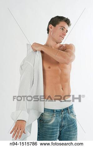 Half-length photograph of a teenage boy standing by getting a white shirt. View Large Photo Image Stock Photograph - Half-length photograph of a teenage boy standing by getting a white shirt.. Fotosearch
