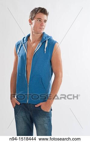Half-length photograph of a teenage boy, with blue jeans and sleeveless vest. View Large Photo Image Picture - Half-length photograph of a teenage boy, with blue jeans and sleeveless vest.. Fotosearch