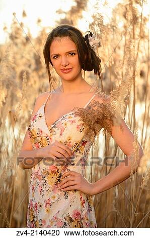Half-length Portrait of a good looking young woman in the reeds at sunset in early spring. View Large Photo Image Stock Image - Half-length Portrait of a good looking young woman in the reeds at sunset in early spring.. Fotosearch