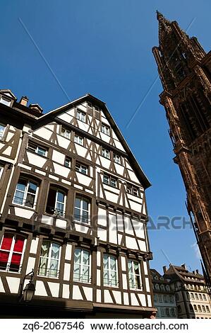 Stock Photograph - Half Timbered House and Cathedral in Strasbourg, Alsace, France.. Fotosearch