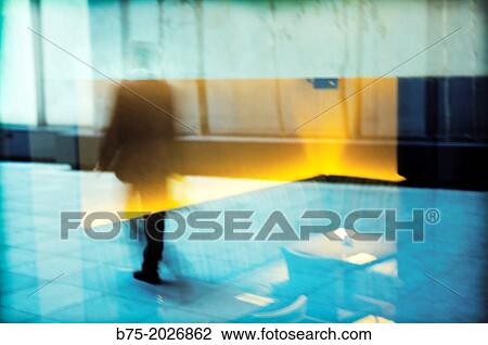 Stock Image - Hall of an office building with a unrecognizable executive, City, London, England, UK. Fotosearch