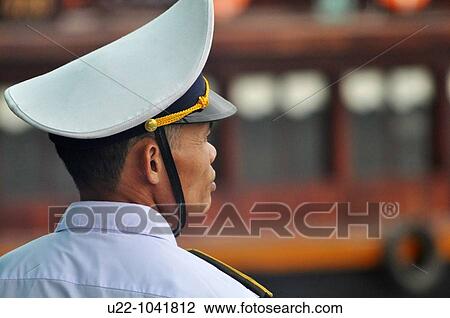 Stock Image - Halong Bay (Vietnam): a boats traffic inspector in uniform. Fotosearch