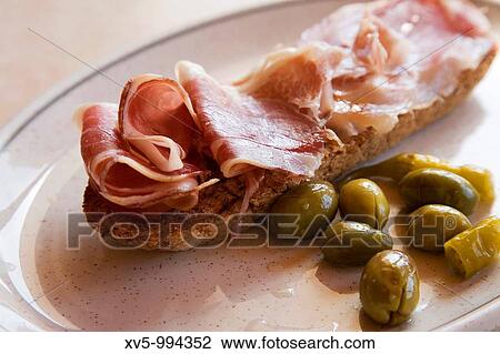 Ham Toast with olives. Spain View Large Photo Image Stock Image - Ham Toast with olives. Spain. Fotosearch