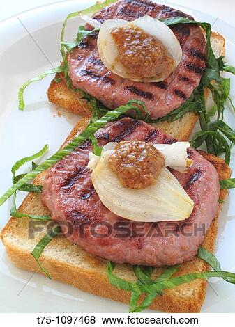 Stock Photo - Hamburger with onion, lettuce and mustard. Fotosearch