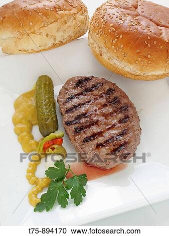 Stock Image - Hamburger with salt, mustard and sesame bread. Fotosearch