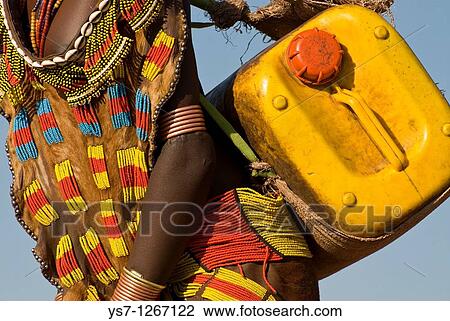 Hamer girl carrying water can, Turmi, Omo region, Ethiopia View Large Photo Image Stock Image - Hamer girl carrying water can, Turmi, Omo region, Ethiopia. Fotosearch