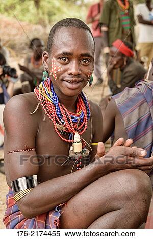 Hamer warrior at a bull jumping ceremony in the Omo Valley, Ethiopia. Jumping a lineup of cattle is a rite of passage into manhood for young Hamer men. They must successfully jump a line of bulls four times in order to marry and own their own livestock. View Large Photo Image Stock Photography - Hamer warrior at a bull jumping ceremony in the Omo Valley, Ethiopia. Jumping a lineup of cattle is a rite of passage into manhood for young Hamer men. They must successfully jump a line of bulls four times in order to marry and own their own livestock.. Fotosearch