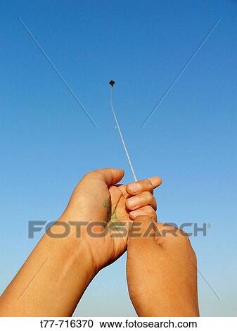 Hand and kite in flight, a boy playing with a kite Pune, Maharashtra, India View Large Photo Image Stock Image - Hand and kite in flight, a boy playing with a kite Pune, Maharashtra, India. Fotosearch