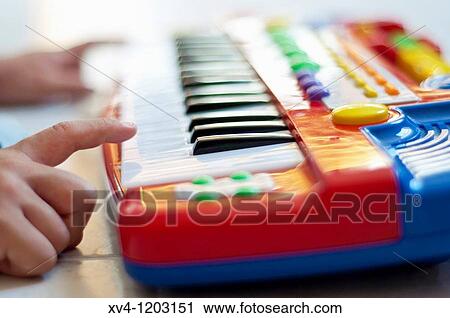 Hand boy playing electronic piano View Large Photo Image Stock Image - Hand boy playing electronic piano. Fotosearch