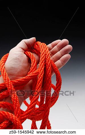 hand clutching orange colored rope View Large Photo Image Stock Image - hand clutching orange colored rope. Fotosearch