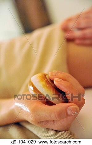 Hand gripping shell during massage View Large Photo Image Stock Photo - Hand gripping shell during massage. Fotosearch
