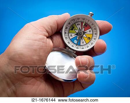 Hand holding a compass View Large Photo Image Picture - Hand holding a compass. Fotosearch