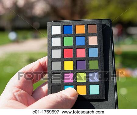 Hand holding a photographic color rendition chart, Strasbourg, Alsace, France View Large Photo Image Stock Photo - Hand holding a photographic color rendition chart, Strasbourg, Alsace, France. Fotosearch