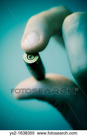 Hand holding bullet View Large Photo Image Stock Photography - Hand holding bullet. Fotosearch
