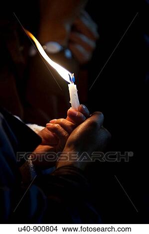 Picture - Hand holding candle. Fotosearch