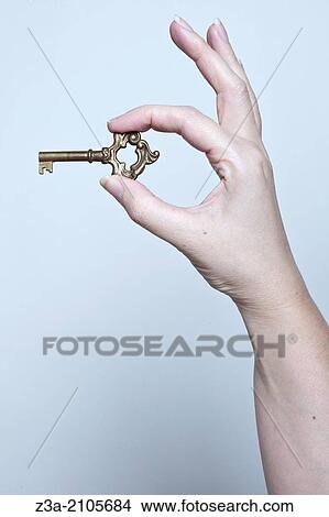 Picture - Hand Holding Key, Hand Gesture, Studio shot. Fotosearch