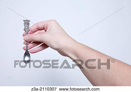 Hand Holding Little Antique Silver Spoon, Hand Gesture, Studio shot View Large Photo Image Stock Photo - Hand Holding Little Antique Silver Spoon, Hand Gesture, Studio shot. Fotosearch