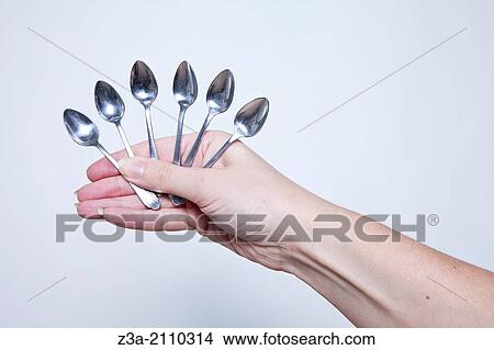 Hand Holding Little Spoons, Hand Gesture, Studio shot View Large Photo Image Picture - Hand Holding Little Spoons, Hand Gesture, Studio shot. Fotosearch