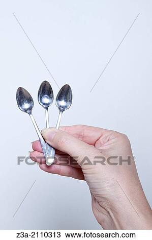Hand Holding Little Spoons, Hand Gesture, Studio shot View Large Photo Image Stock Image - Hand Holding Little Spoons, Hand Gesture, Studio shot. Fotosearch