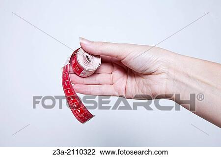 Hand Holding Measuring Tape, Hand Gesture, Studio shot View Large Photo Image Stock Image - Hand Holding Measuring Tape, Hand Gesture, Studio shot. Fotosearch