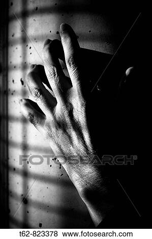 Stock Photo - Hand in the wall Anguish. Fotosearch