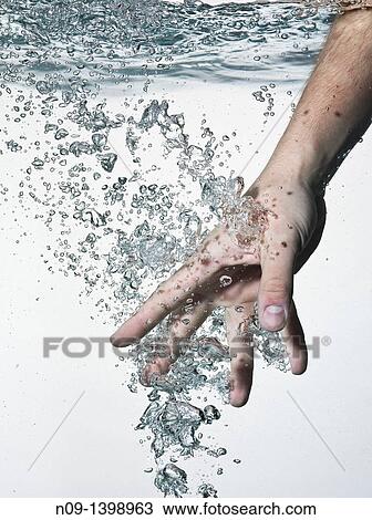 Hand in water on a white background View Large Photo Image Stock Image - Hand in water on a white background. Fotosearch