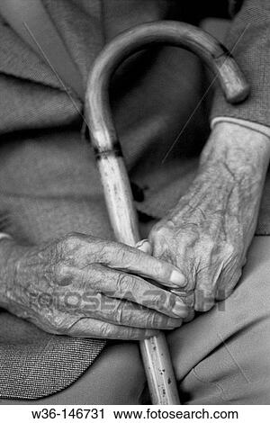 Stock Image - Hand of old man with walking stick. Fotosearch