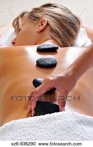 Hand placing hot stone for therapy View Large Photo Image Stock Image - Hand placing hot stone for therapy. Fotosearch