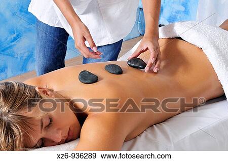 Hand placing hot stone for therapy View Large Photo Image Stock Photo - Hand placing hot stone for therapy. Fotosearch