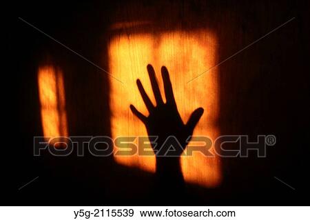 Stock Photo - hand shadow on wooden door. Fotosearch
