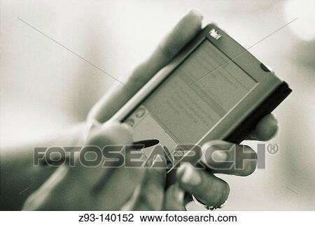 Hand using palm pilot View Large Photo Image Stock Image - Hand using palm pilot. Fotosearch