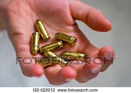 Stock Image - Hand with bullets. Fotosearch