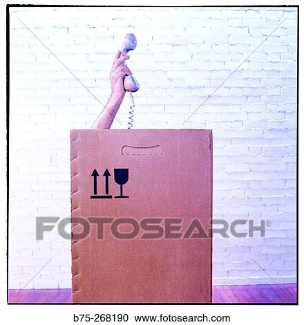 Hand with telephone inside a cardboard box View Large Photo Image Stock Image - Hand with telephone inside a cardboard box. Fotosearch