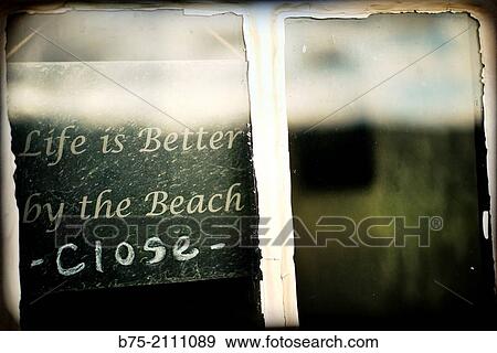 Hand writen ad in a window of a business. Life is better by the beach. Closed. North Yorkshire, England, UK, Europe. View Large Photo Image Stock Photo - Hand writen ad in a window of a business. Life is better by the beach. Closed. North Yorkshire, England, UK, Europe.. Fotosearch