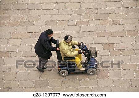 handicapped man being pushed in a wheelchair in Venice italy after the carnival View Large Photo Image Stock Photo - handicapped man being pushed in a wheelchair in Venice italy after the carnival. Fotosearch