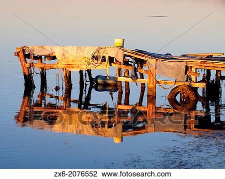 Handmade pallet pier reflection, Alfacs Bay. Ebro River Delta Natural Park, Tarragona province, Catalonia, Spain. View Large Photo Image Stock Image - Handmade pallet pier reflection, Alfacs Bay. Ebro River Delta Natural Park, Tarragona province, Catalonia, Spain.. Fotosearch