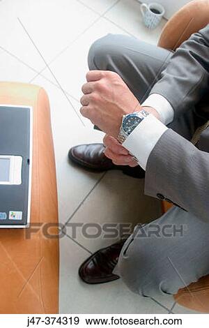 Hands and feet of a business man sitting at computer View Large Photo Image Stock Photo - Hands and feet of a business man sitting at computer. Fotosearch