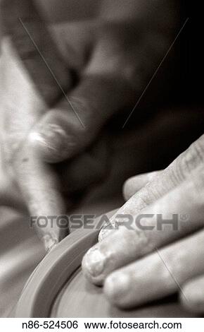 Hands gliding along a wet clay bowl View Large Photo Image Stock Photograph - Hands gliding along a wet clay bowl. Fotosearch
