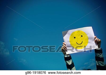 Hands holding a smiled icon View Large Photo Image Stock Photograph - Hands holding a smiled icon. Fotosearch